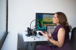 Person sitting in chair speaking into microphone